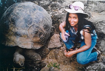 Celeste Horner crouching next to a tortoise in the Galapagos